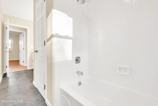 bathroom featuring tiled shower / bath combo and hardwood / wood-style flooring