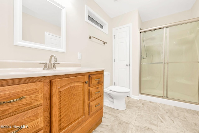 bathroom with vanity, toilet, and an enclosed shower