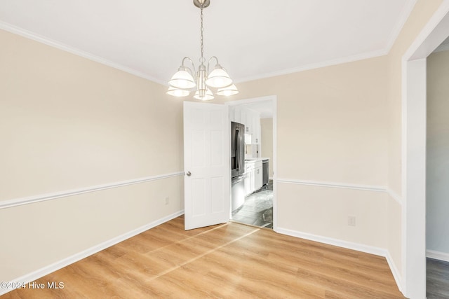 unfurnished dining area featuring hardwood / wood-style floors, a chandelier, and ornamental molding