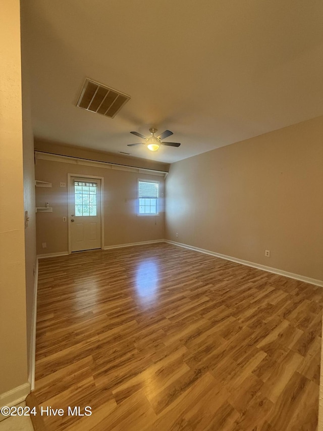 empty room featuring ceiling fan and light wood-type flooring