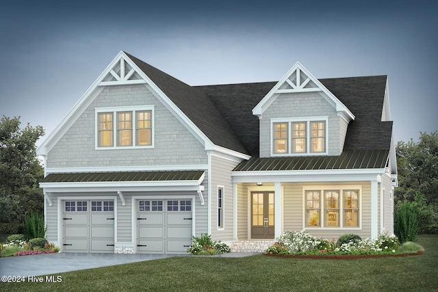 view of front of house with a garage and a front yard