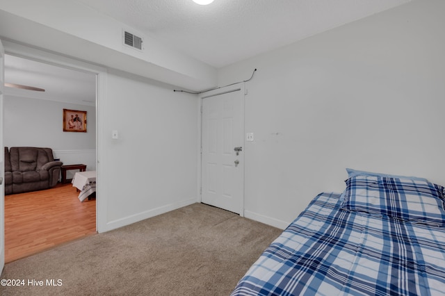 bedroom with a textured ceiling and carpet floors