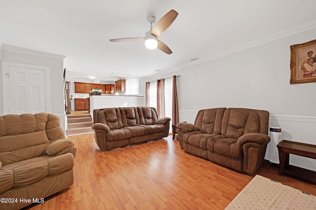 living room featuring light hardwood / wood-style floors, ceiling fan, and ornamental molding