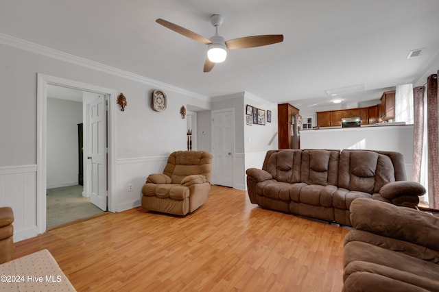 living room featuring ceiling fan, light hardwood / wood-style floors, and ornamental molding