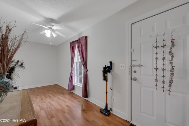 entrance foyer featuring a textured ceiling, hardwood / wood-style flooring, and ceiling fan