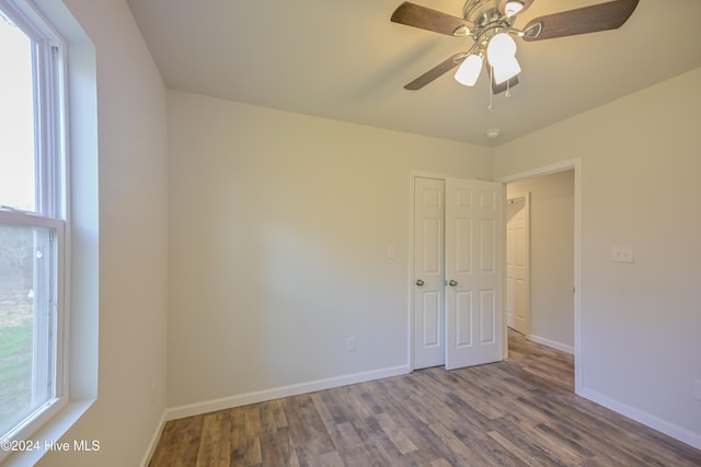 empty room with ceiling fan and wood-type flooring