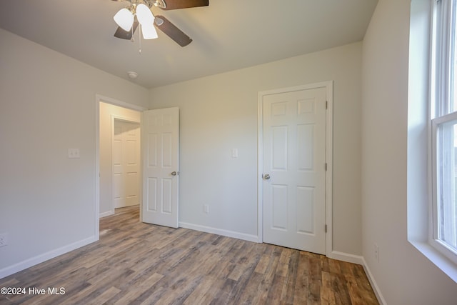 unfurnished bedroom with hardwood / wood-style floors and ceiling fan