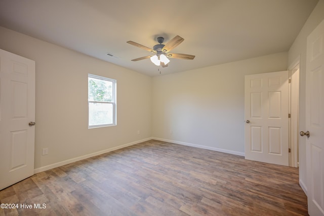 spare room featuring ceiling fan and hardwood / wood-style floors