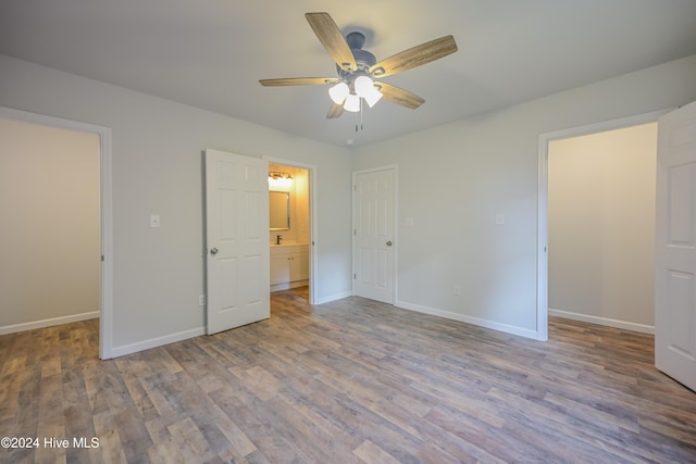 unfurnished bedroom featuring a closet, light hardwood / wood-style flooring, and ceiling fan