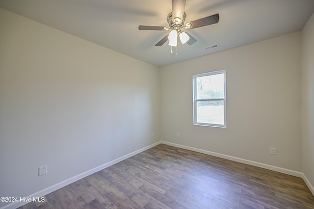 spare room with ceiling fan and dark wood-type flooring