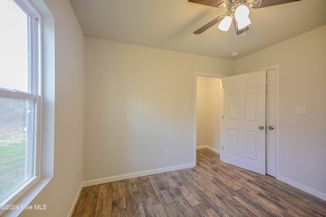 spare room with ceiling fan and dark hardwood / wood-style flooring