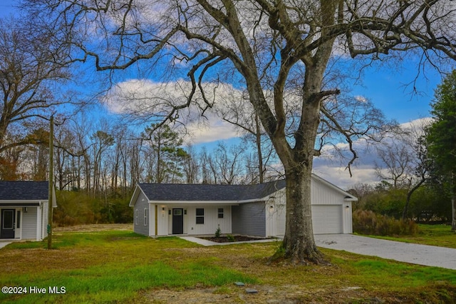 ranch-style home with a garage and a front lawn