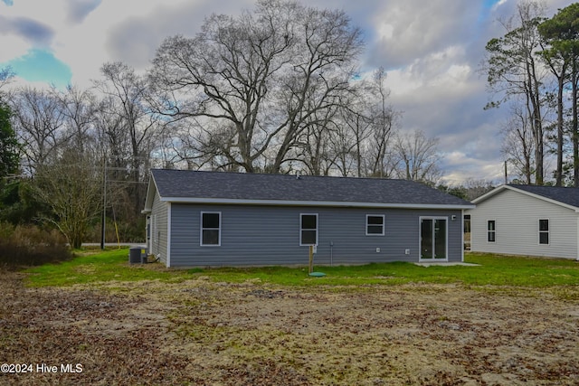 rear view of property with a lawn