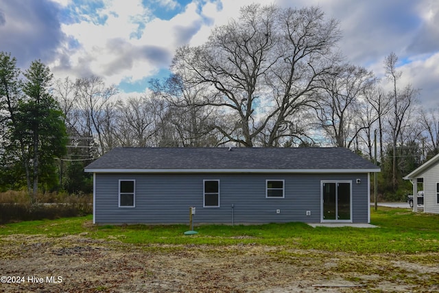 rear view of house with a lawn