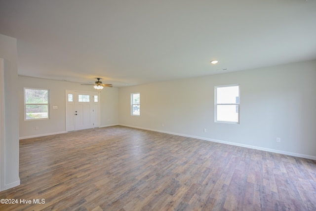 spare room with hardwood / wood-style floors and ceiling fan