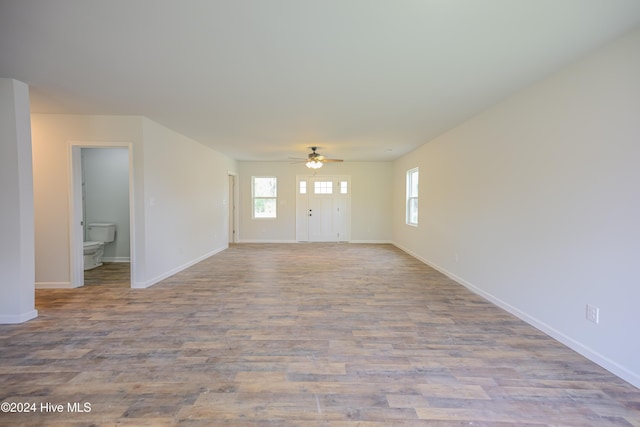 unfurnished living room featuring ceiling fan and light hardwood / wood-style floors