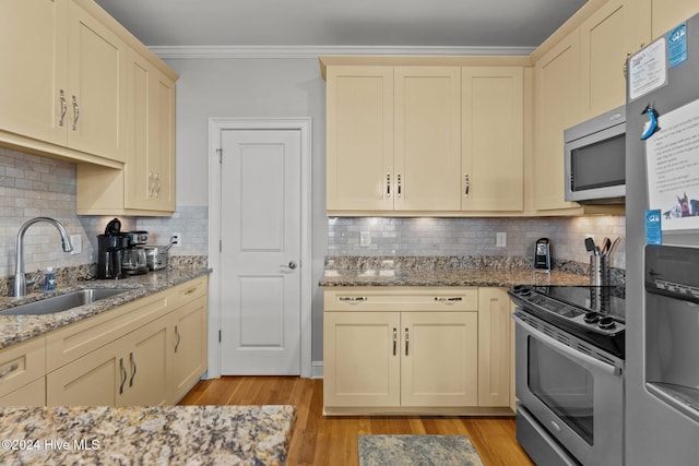 kitchen featuring decorative backsplash, appliances with stainless steel finishes, and sink