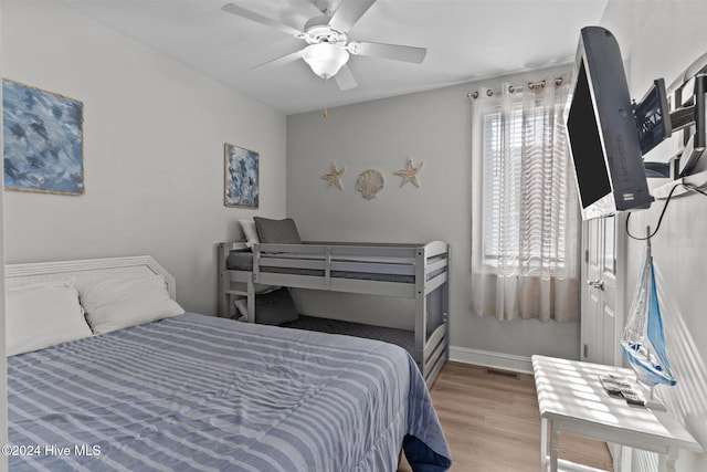 bedroom with ceiling fan and hardwood / wood-style flooring