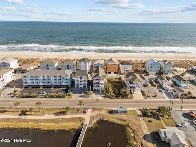 bird's eye view with a water view and a beach view