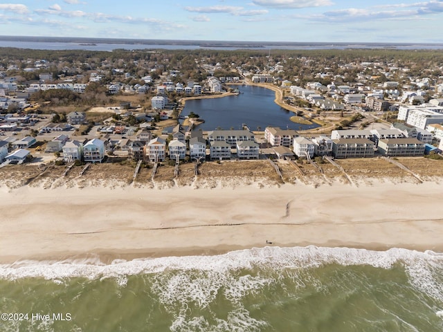 birds eye view of property featuring a water view and a view of the beach