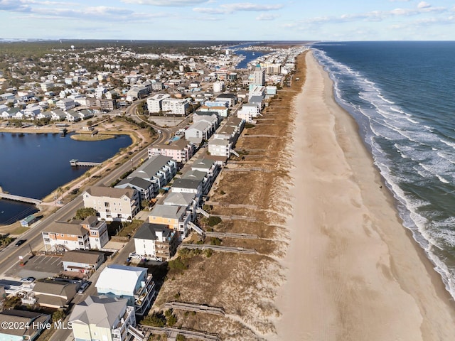 drone / aerial view featuring a water view and a view of the beach