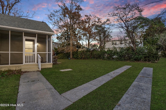 yard at dusk with a sunroom