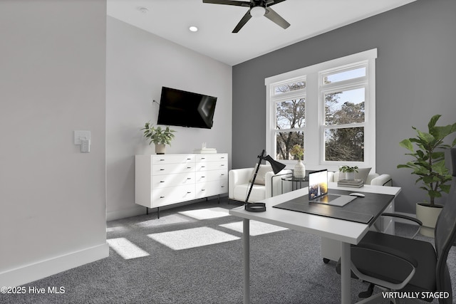 office area with ceiling fan and dark colored carpet