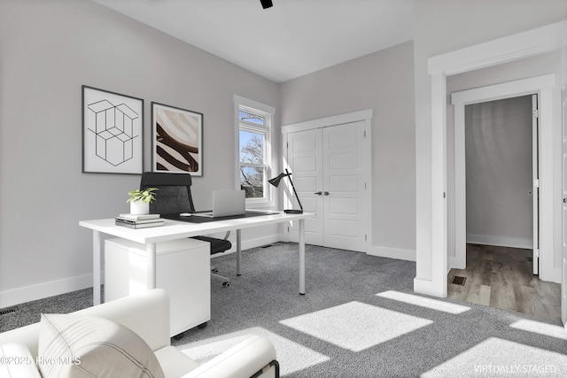 office area featuring dark colored carpet