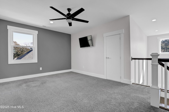 carpeted empty room featuring ceiling fan