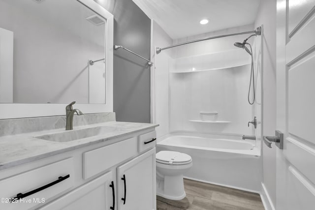 full bathroom with toilet, wood-type flooring, bathtub / shower combination, and vanity