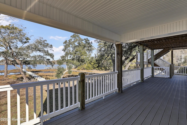 wooden deck featuring a water view