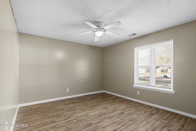 unfurnished room featuring hardwood / wood-style floors, a textured ceiling, and ceiling fan