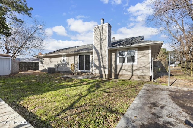 back of property featuring a lawn, central AC, and a patio area