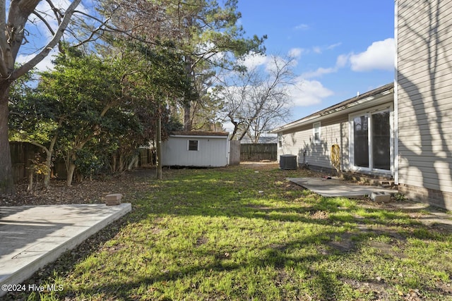 view of yard featuring a patio area, a shed, and central AC unit