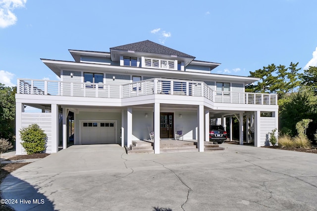 view of front of house with a garage and a carport