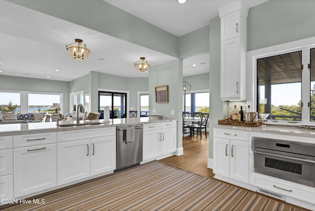 kitchen featuring light hardwood / wood-style floors, sink, white cabinets, and appliances with stainless steel finishes