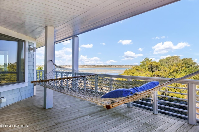 wooden terrace featuring a water view