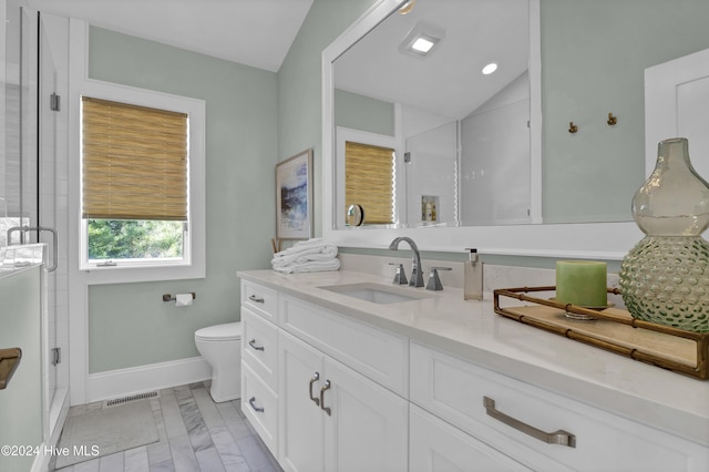 bathroom featuring walk in shower, vanity, toilet, and vaulted ceiling