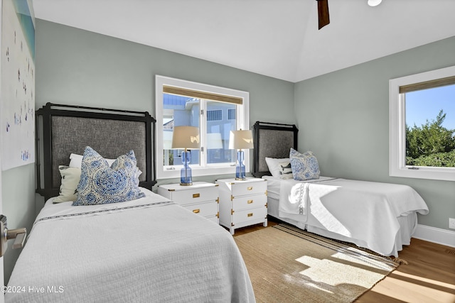 bedroom featuring ceiling fan, lofted ceiling, and light hardwood / wood-style floors