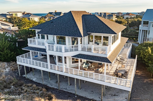 rear view of property featuring a balcony