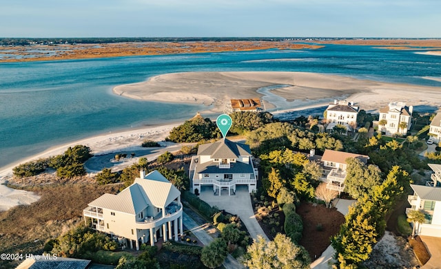 birds eye view of property with a water view and a view of the beach