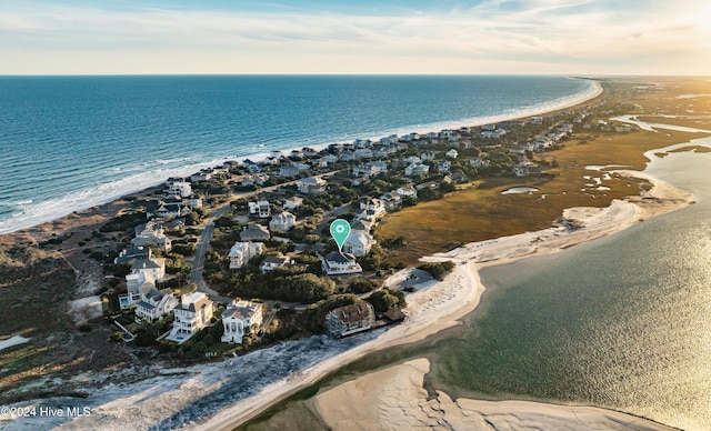 birds eye view of property with a water view and a view of the beach