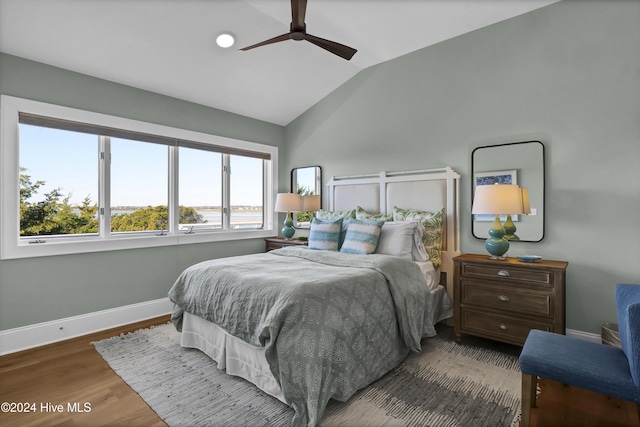 bedroom with ceiling fan, lofted ceiling, and hardwood / wood-style flooring