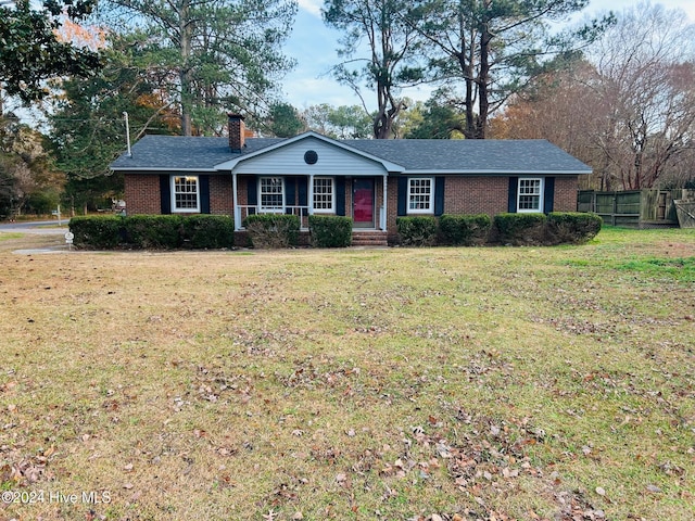 ranch-style home featuring a front yard