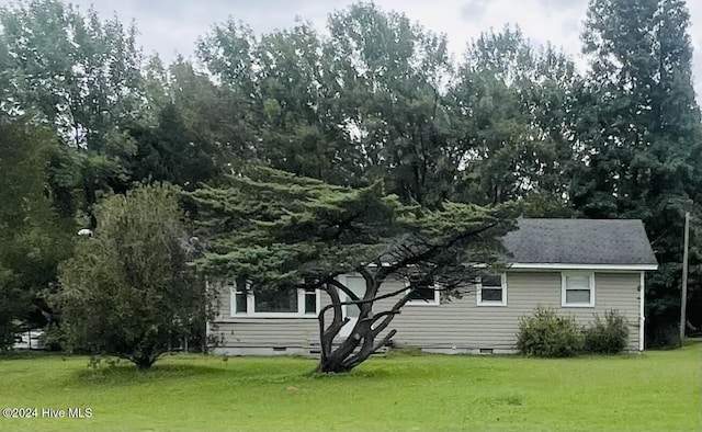 view of home's exterior with a lawn