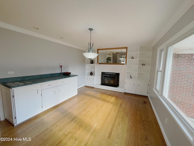 unfurnished living room featuring light wood-type flooring and crown molding