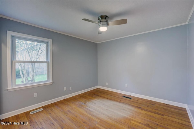 empty room with ceiling fan, light hardwood / wood-style floors, and crown molding