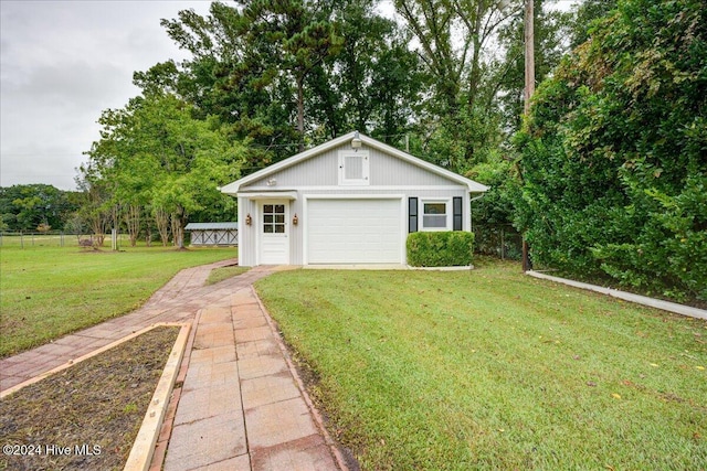 exterior space featuring a garage and a lawn