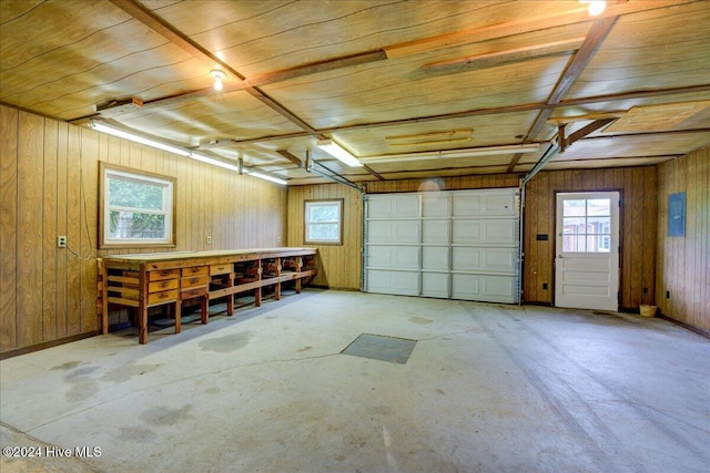 garage with wood walls, wood ceiling, and electric panel