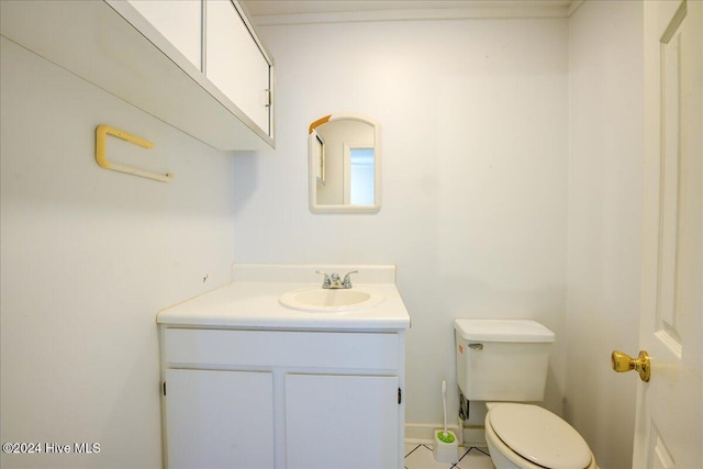 bathroom featuring tile patterned flooring, vanity, and toilet